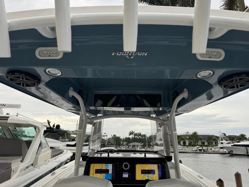 Slide: The Image of 2019 Fountain 38 CC boat interior with navigation screens and overhead canopy. - 16