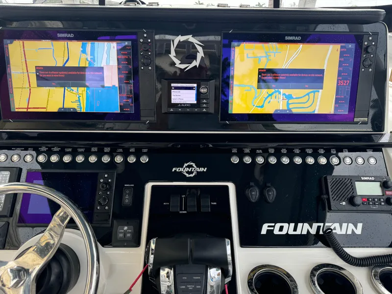 Slide: The Image of 2019 Fountain 38 CC boat dashboard with dual Simrad navigation screens. - 17