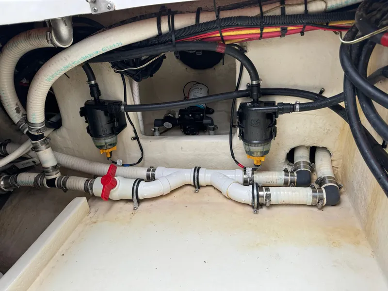 Slide: The Image of 2019 Fountain 38 CC boat plumbing system with hoses and valves. - 22