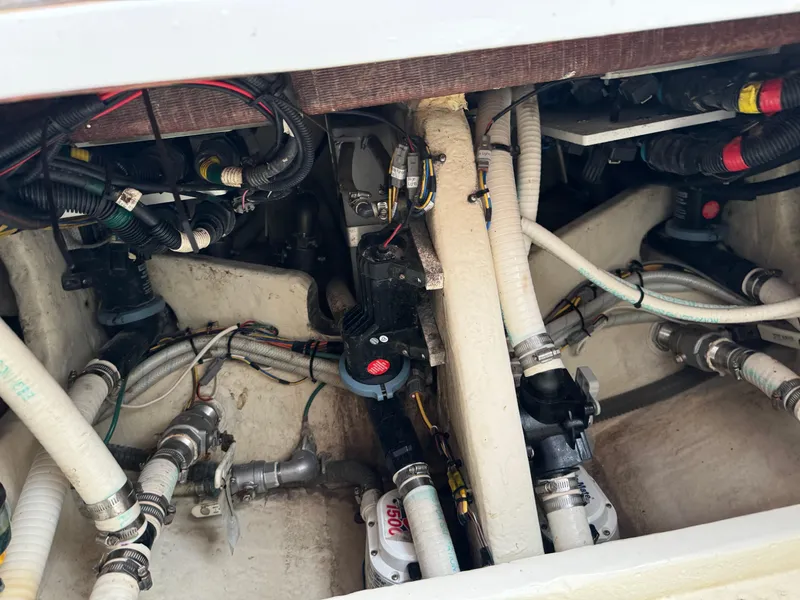 Slide: The Image of Engine compartment of a 2019 Fountain 38 CC boat, showcasing wiring and plumbing. - 23