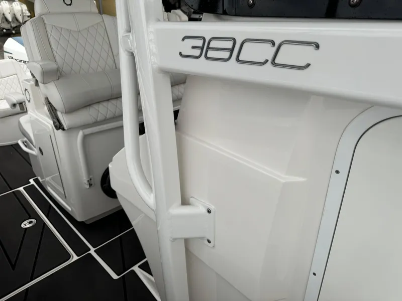 Slide: The Image of 2019 Fountain 38 CC boat interior with white seating and sleek design. - 25