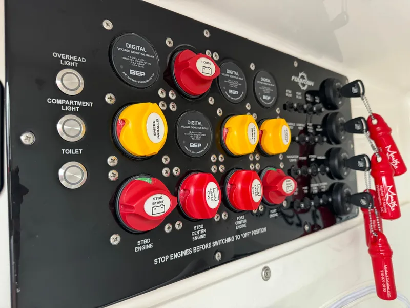 Slide: The Image of Control panel of a 2019 Fountain 38 CC boat with labeled switches and keys. - 26