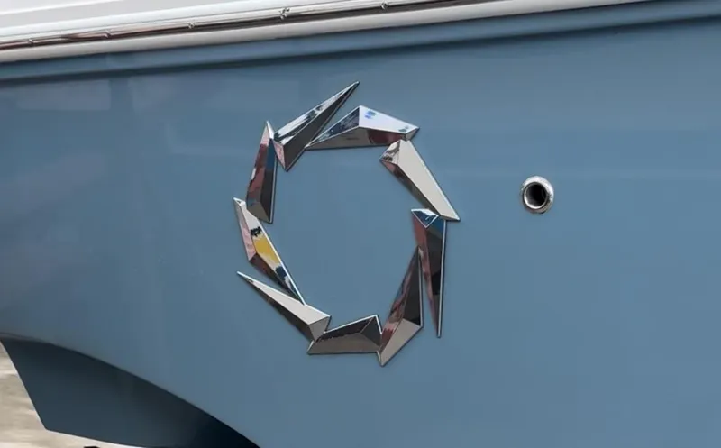 Slide: The Image of 2019 Fountain 38 CC boat with chrome emblem on blue hull. - 28