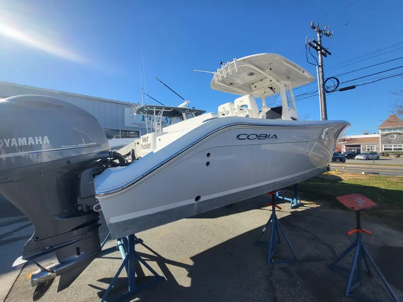 Slide: The Image of 2021 Cobia 280 Center Console boat on stands, featuring Yamaha outboard motor. - 14
