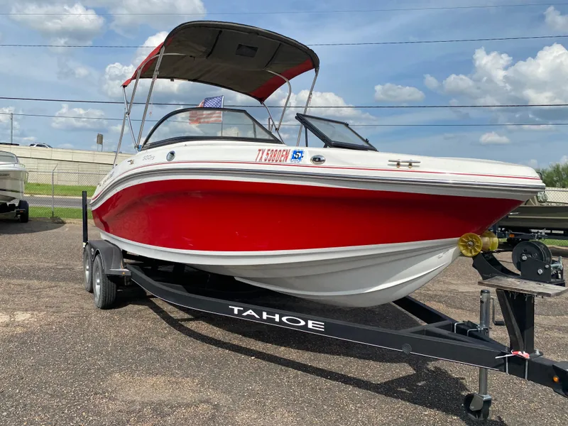 Slide: The Image of 2019 Tahoe 500 TS boat on trailer, red and white design, parked outdoors. - 1