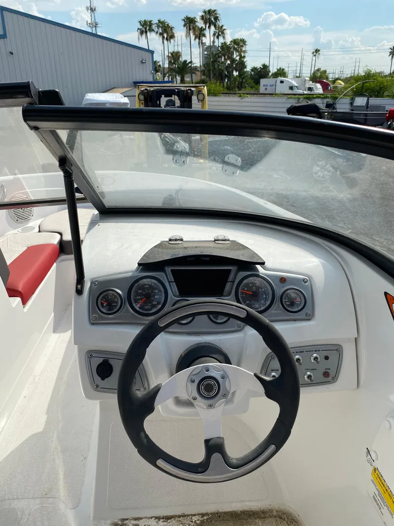 Slide: The Image of 2019 Tahoe 500 TS boat dashboard with steering wheel and gauges. - 10