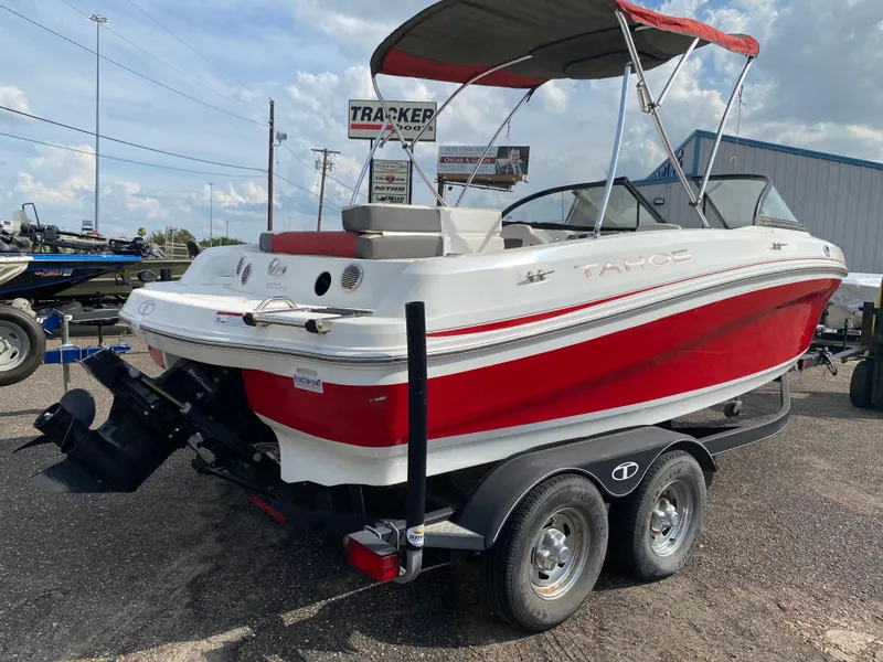 Slide: The Image of 2019 Tahoe 500 TS boat, red and white, on a trailer in a parking lot. - 5