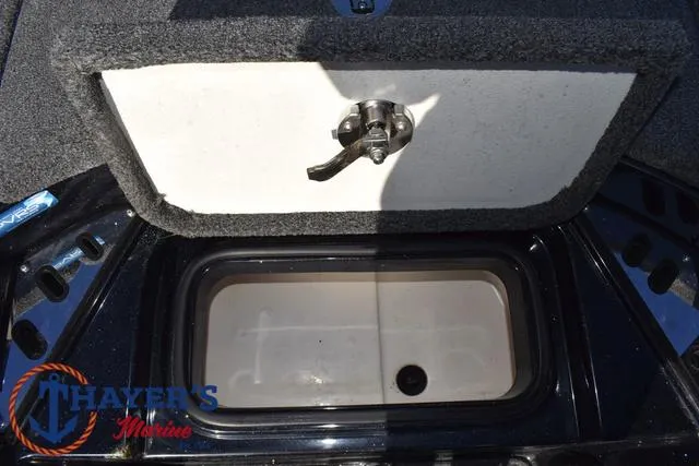 Slide: The Image of 2021 Ranger Z520L boat storage compartment with latch, Thayer's Marine logo visible. - 20