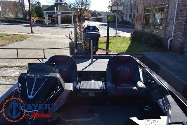 Slide: The Image of 2021 Ranger Z520L boat with dual seats, parked outdoors near Thayer's Marine. - 21