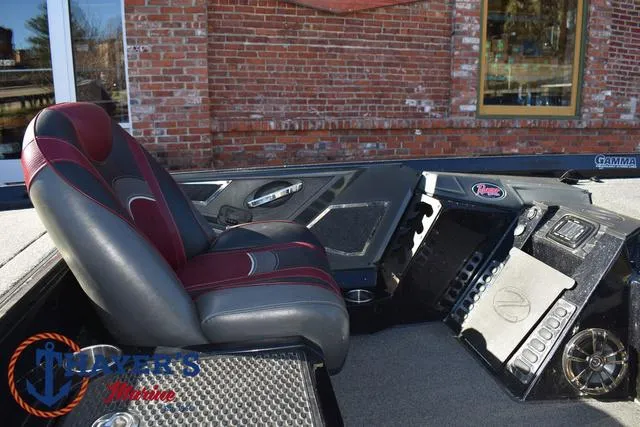 Slide: The Image of 2021 Ranger Z520L boat interior with red and gray seating, dashboard, and controls. - 23