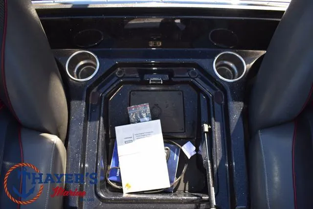 Slide: The Image of 2021 Ranger Z520L boat interior with storage compartment and cup holders. - 26