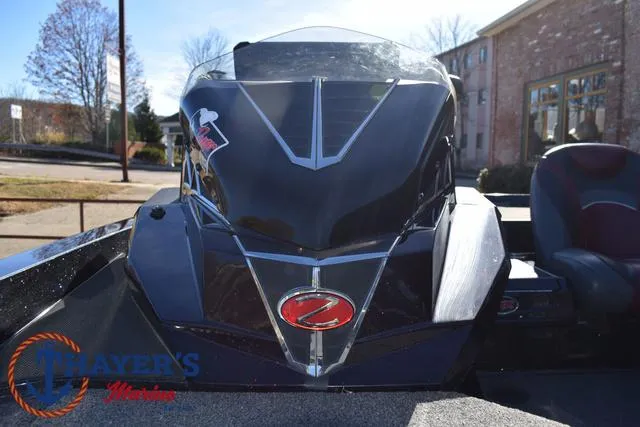 Slide: The Image of 2021 Ranger Z520L boat with sleek black design and logo, parked outdoors. - 27