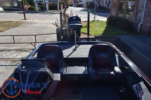 Slide: The Image of 2021 Ranger Z520L boat with dual seats and motor, parked outdoors. - 34