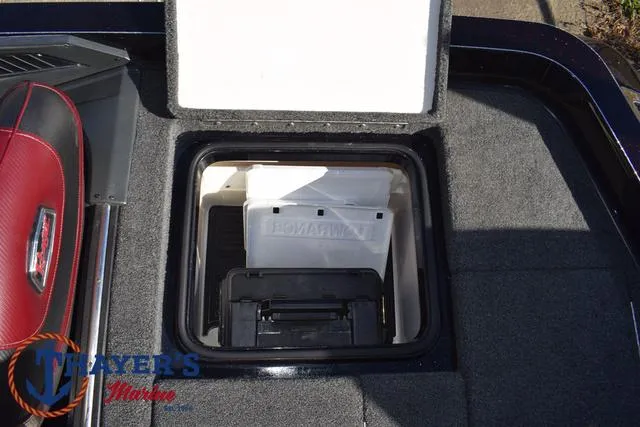 Slide: The Image of Open storage compartment in 2021 Ranger Z520L boat with visible tackle boxes. - 36