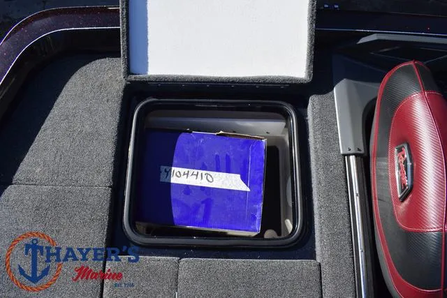 Slide: The Image of Open storage compartment in 2021 Ranger Z520L boat with blue box inside. - 37