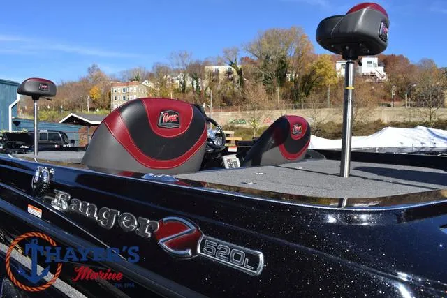 Slide: The Image of 2021 Ranger Z520L boat with red and black seats, outdoors at Thayer's Marine. - 45