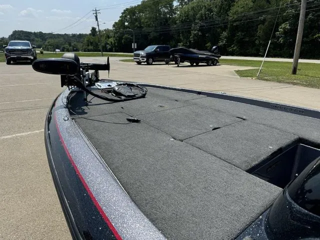 Slide: The Image of 2011 Skeeter ZX 190 boat in parking lot, featuring spacious deck and trolling motor. - 12