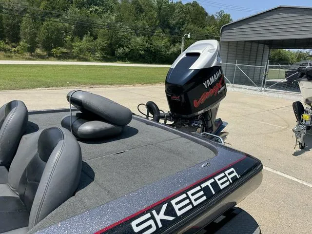 Slide: The Image of 2011 Skeeter ZX 190 boat with Yamaha engine, parked outdoors. - 13