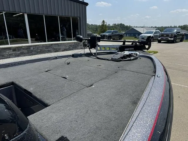 Slide: The Image of 2011 Skeeter ZX 190 boat with trolling motor, parked outside a building. - 6