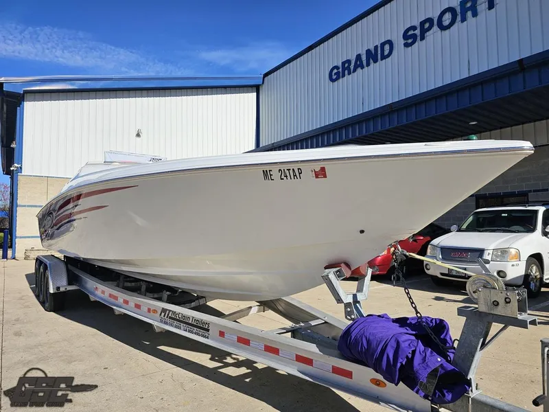 Slide: The Image of 2004 Baja 33 Outlaw boat on trailer outside Grand Sport Center. - 13