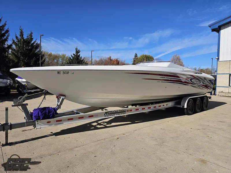 Slide: The Image of 2004 Baja 33 Outlaw speedboat on trailer, parked outdoors under clear blue sky. - 15