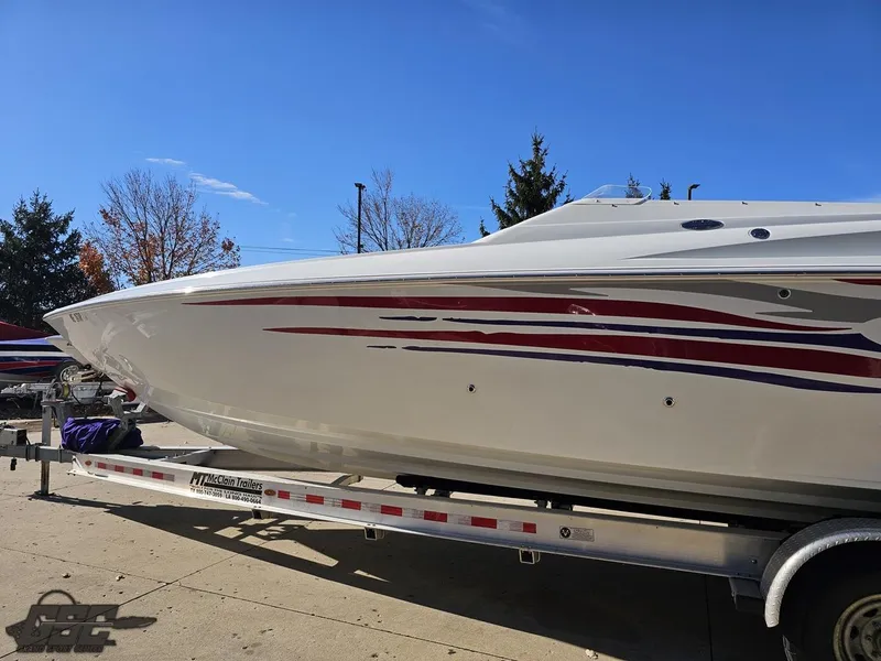 Slide: The Image of 2004 Baja 33 Outlaw boat on trailer, featuring sleek design and vibrant graphics. - 20