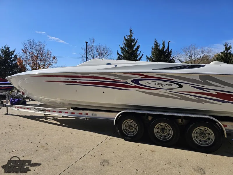 Slide: The Image of 2004 Baja 33 Outlaw speedboat on a trailer, featuring sleek design and vibrant graphics. - 21