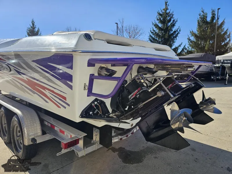 Slide: The Image of 2004 Baja 33 Outlaw boat on trailer, featuring vibrant graphics and dual propellers. - 27