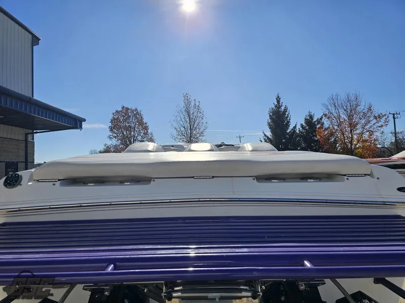 Slide: The Image of 2004 Baja 33 Outlaw boat under clear blue sky, rear view. - 29