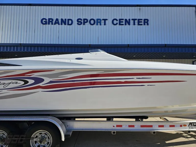 Slide: The Image of 2004 Baja 33 Outlaw boat at Grand Sport Center, featuring sleek design and vibrant graphics. - 3