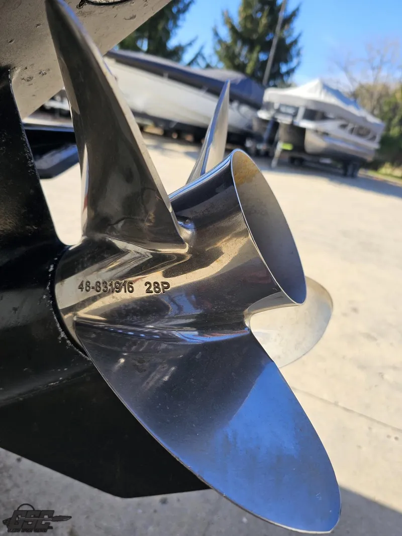 Slide: The Image of Close-up of a 2004 Baja 33 Outlaw boat propeller, showcasing its polished metal blades. - 30