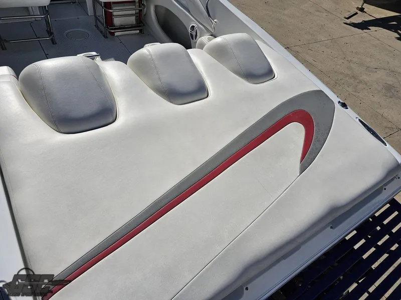 Slide: The Image of 2004 Baja 33 Outlaw boat interior with white and red seating design. - 33