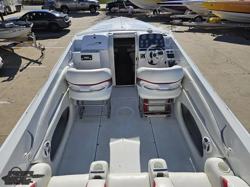 Slide: The Image of 2004 Baja 33 Outlaw boat interior with white seating and steering console. - 35