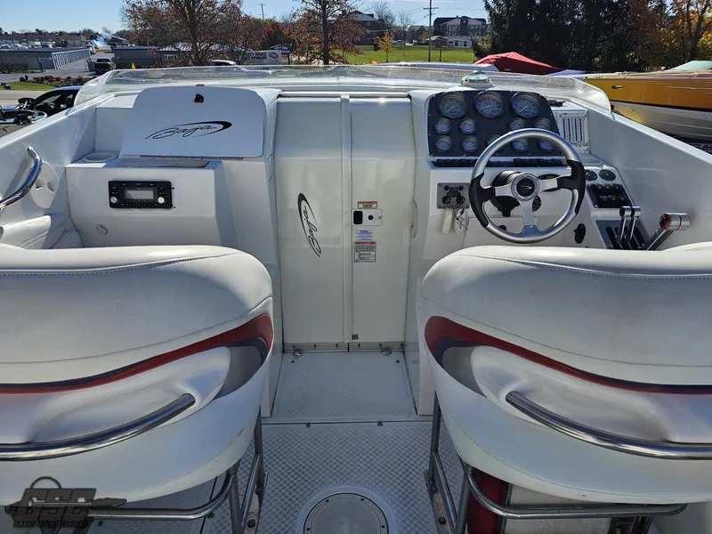 Slide: The Image of 2004 Baja 33 Outlaw boat cockpit with white seats and control panel. - 38