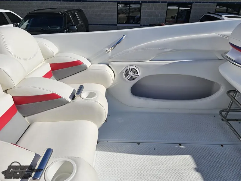 Slide: The Image of 2004 Baja 33 Outlaw boat interior with white and red seating, cup holders, and speaker. - 39
