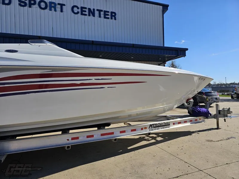 Slide: The Image of 2004 Baja 33 Outlaw boat on trailer outside sports center. - 4