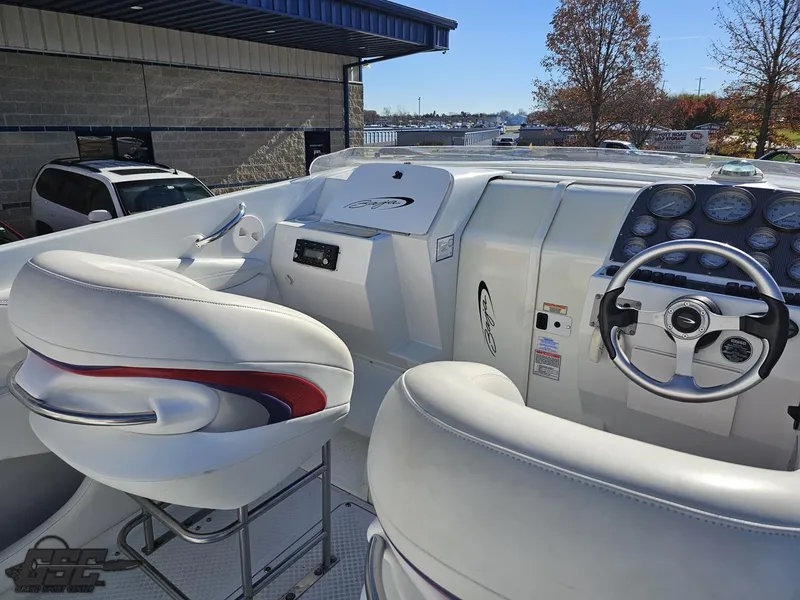 Slide: The Image of 2004 Baja 33 Outlaw boat cockpit with white seating and control panel. - 40