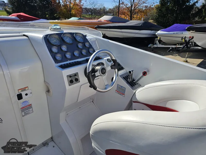 Slide: The Image of 2004 Baja 33 Outlaw boat cockpit with steering wheel and gauges. - 43