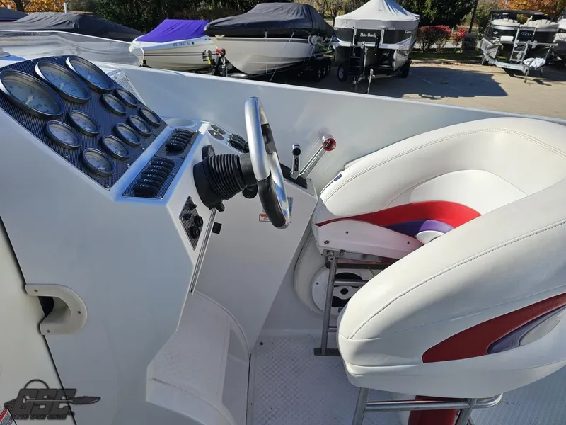 Slide: The Image of 2004 Baja 33 Outlaw boat cockpit with steering wheel and gauges. - 44