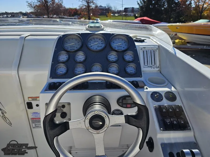 Slide: The Image of 2004 Baja 33 Outlaw boat dashboard with steering wheel and gauges. - 45