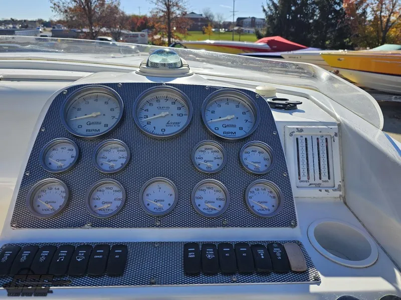 Slide: The Image of Dashboard of a 2004 Baja 33 Outlaw boat with gauges and controls. - 46