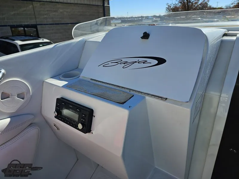 Slide: The Image of 2004 Baja 33 Outlaw boat interior with stereo system and logo. - 48