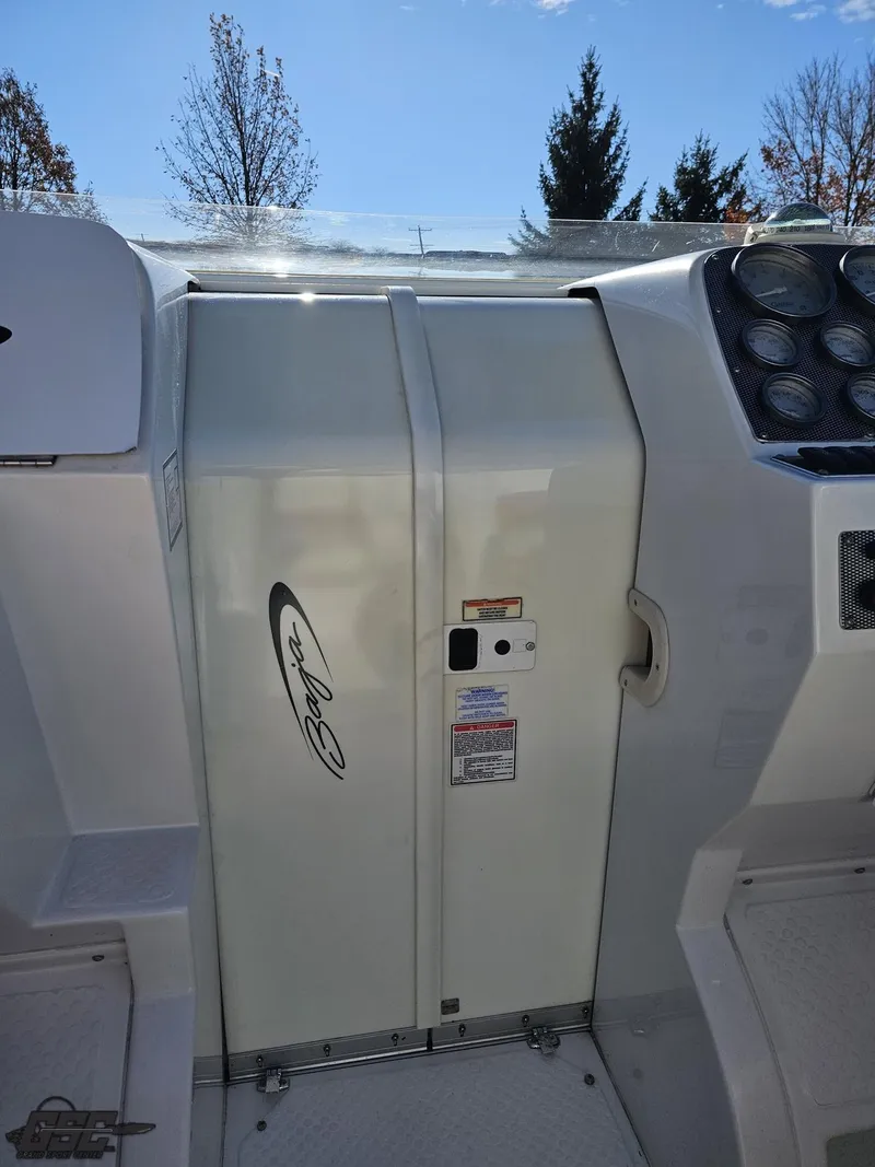 Slide: The Image of 2004 Baja 33 Outlaw boat cockpit with control panel and seating area. - 49