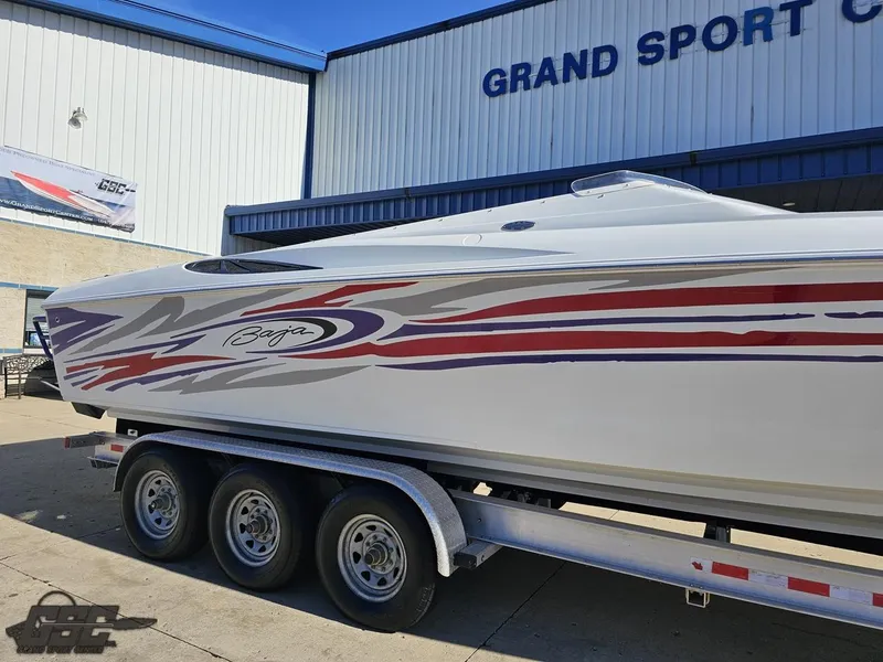 Slide: The Image of 2004 Baja 33 Outlaw boat on trailer at Grand Sport Center. - 5