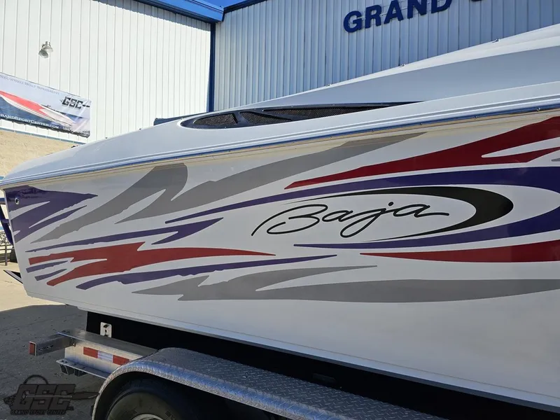 Slide: The Image of 2004 Baja 33 Outlaw boat with colorful graphics on trailer. - 7