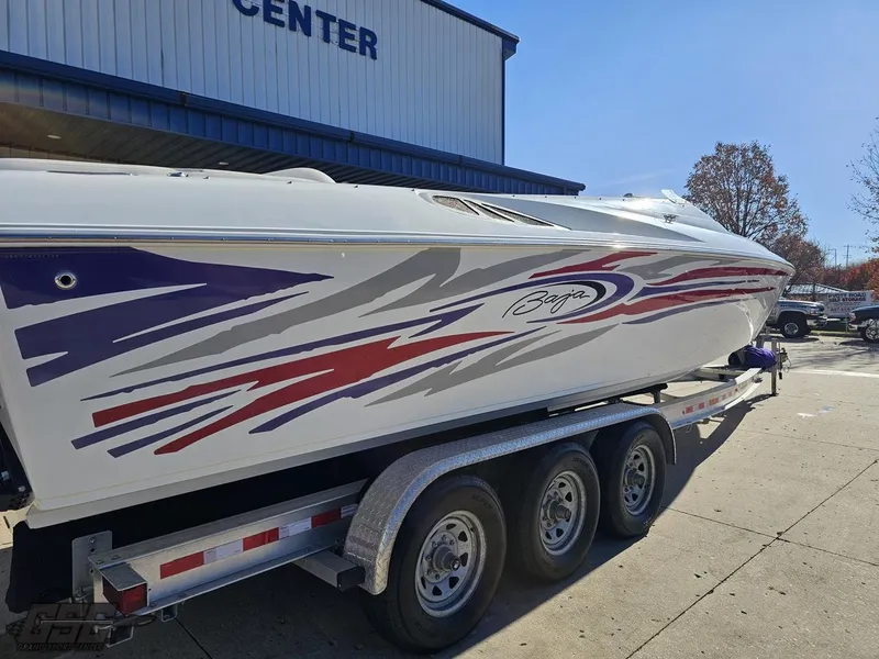 Slide: The Image of 2004 Baja 33 Outlaw boat on trailer with vibrant graphics. - 8
