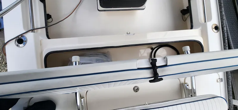 Slide: The Image of Interior view of a 2005 Young Boats Young 20, showcasing storage compartments and seating. - 15