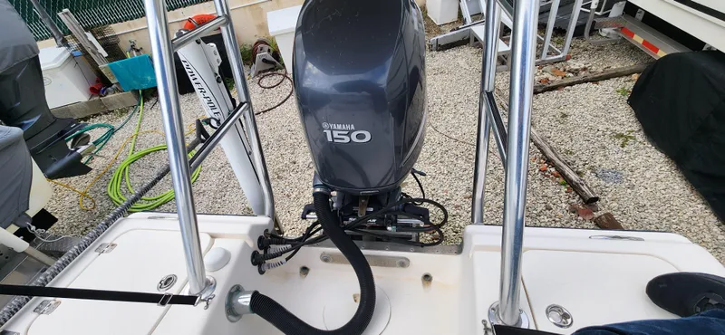 Slide: The Image of 2005 Young Boats Young 20 with Yamaha 150 engine in a gravel yard. - 21