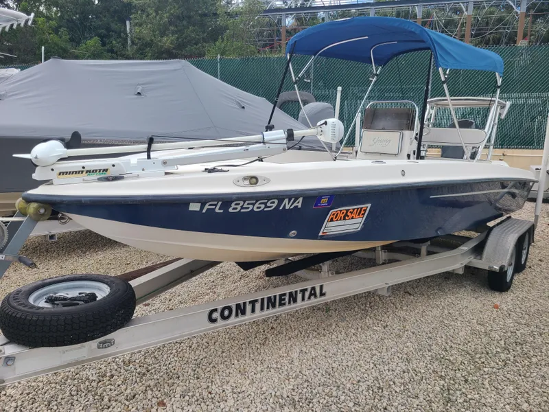 Slide: The Image of 2005 Young Boats Young 20 for sale on trailer, blue hull, with canopy. - 3