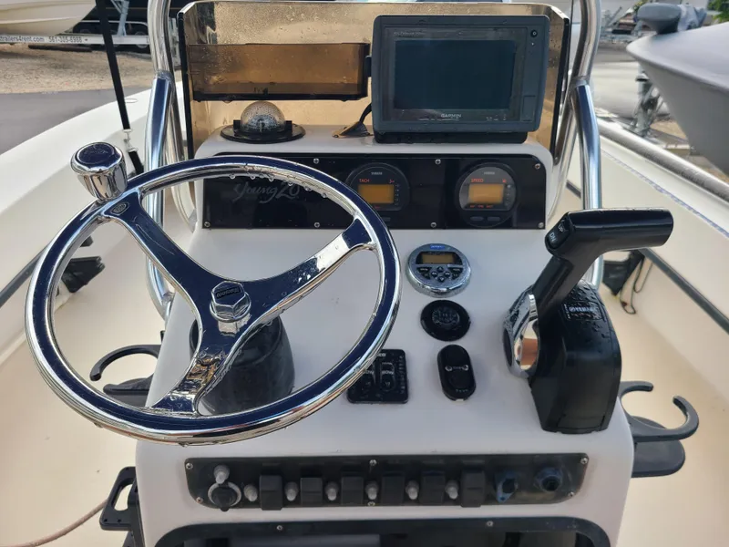 Slide: The Image of 2005 Young Boats Young 20 helm with steering wheel and navigation controls. - 5